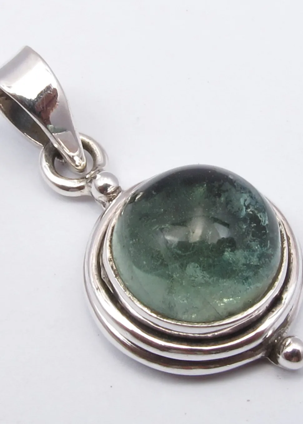 solid_silver_apatite_enca_0.webp Solid Silver Apatite Encased Round Cabochon Pendant